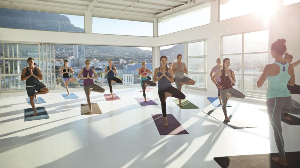 A class practices yoga together in the morning.
