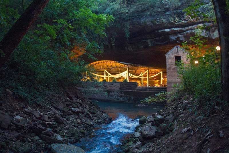 An image of the Lost River Cave in Kentucky, lit by artificial lighting at night.